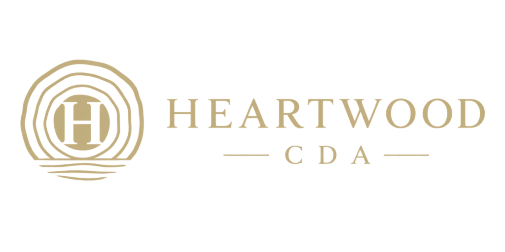 Heartwood CDA logo with gold tree ring emblem and stylized H