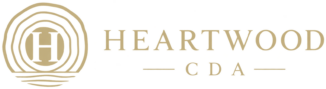 Heartwood CDA logo with gold tree ring emblem and stylized H
